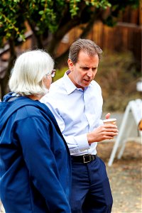 Attendees exchange words with regional director