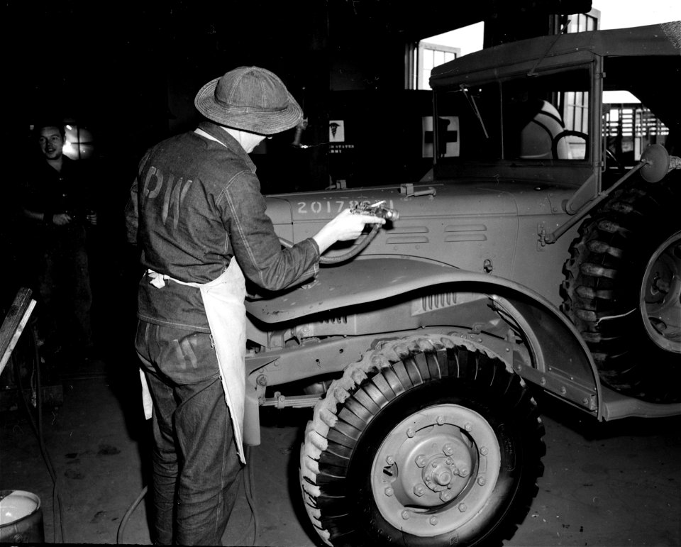 SC 184888 - A German prisoner of war at Camp Wallace, Texas, is shown at work in the Service Command Shop #5 spraying paint on a truck that has been repaired. 1943.