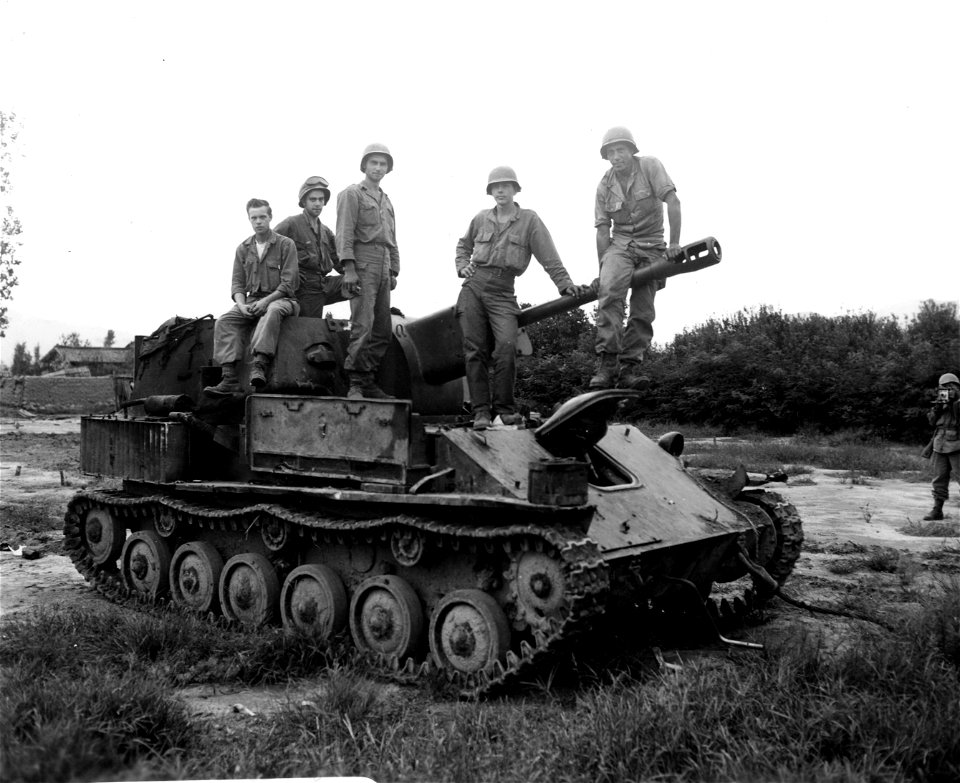 SC 348915 - Men of the 5th RCT pose on a Russian-made SU-76 (self-propelled gun) with back section of turret blown off, captured from North Koreans in the Waegwan area, Korea. 20 September, 1950.