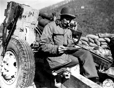 SC 396925 - Reading his first mail since moving into frontline position is Sgt. John W. Carter of Gastonia, N.C., Battery C, 616th F.A. Bn., 10th Mtn. Div. 31 January, 1945. photo