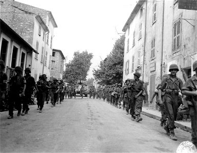 SC 270616 - Soldiers of the 30th Inf. Regt., 3rd Div., marching through the main street of Flassan. 17 August, 1944. photo