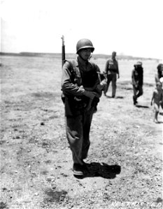 SC 405068 - An American soldier carries a half-starved child too weak to walk.