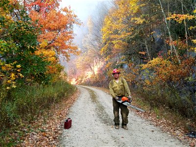 Firefighter holding chainsaw photo