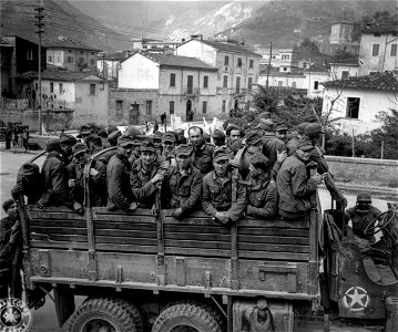 SC 337141 - Truck-load of German prisoners taken by 442nd Regt., 92nd Div., leave Carrara for a prisoner of war cage in the rear area. 13 April, 1945. photo