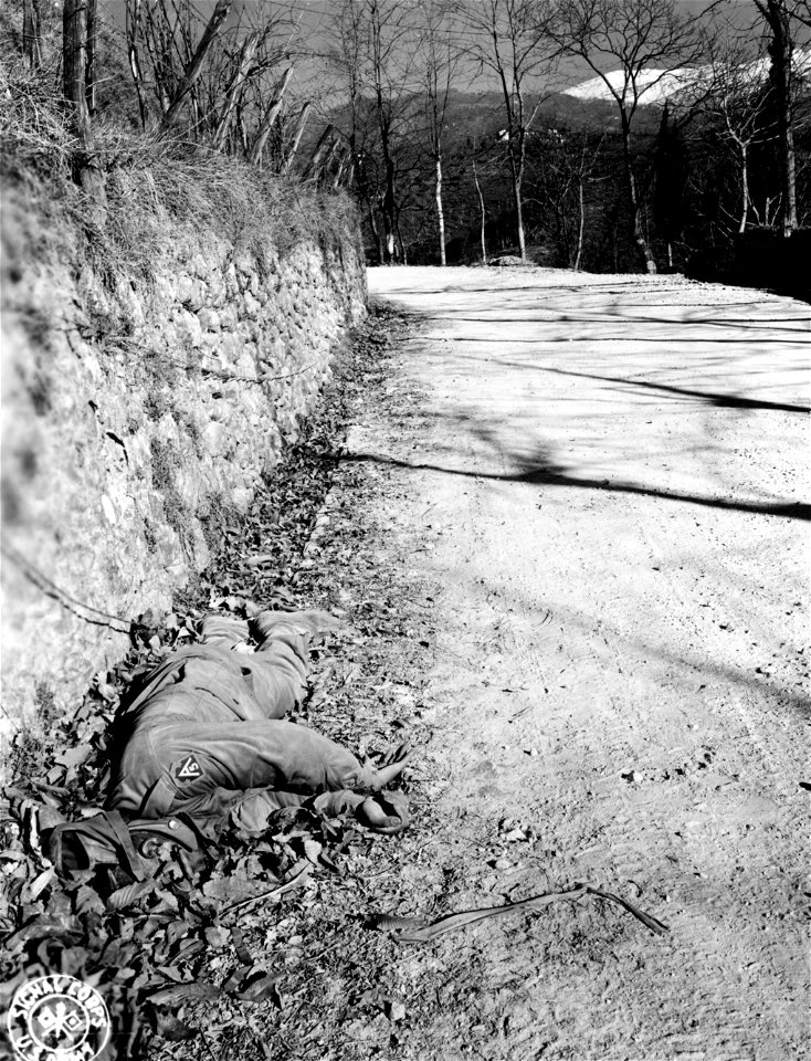 SC 198949 - The body of a dead Negro soldier bears mute testimony to the force of the German drive down the Serchio Valley.