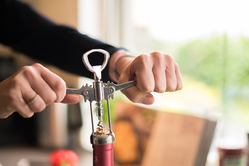 Man Uncorking Wine Bottle