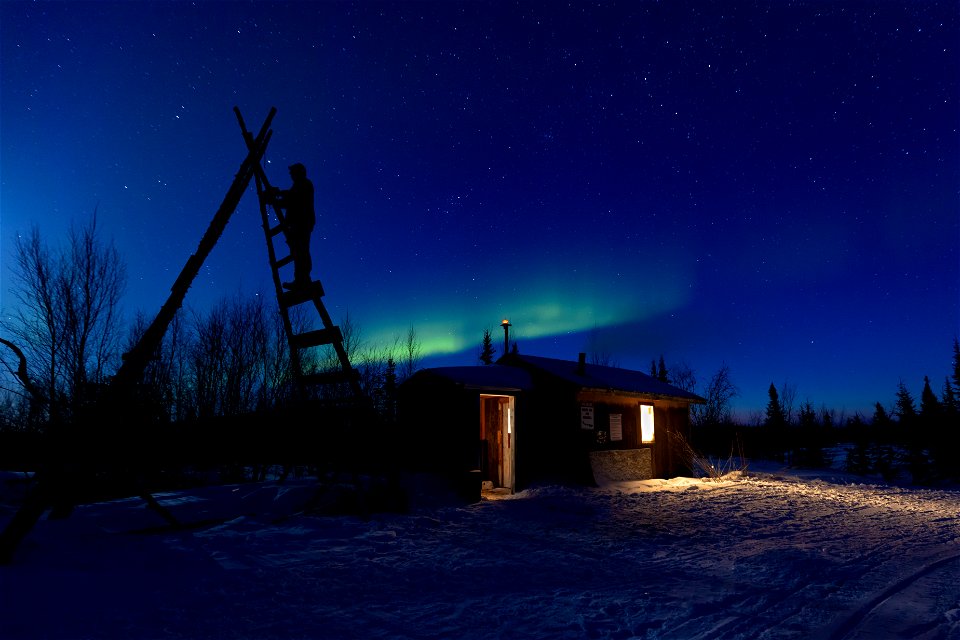 Aurora over Paniqsigvik shelter cabin at Selawik National Wildlife Refuge.