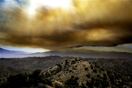 Smoke from the Apple Fire over desert hills