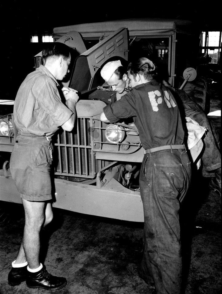 SC 184880 - German war prisoners at Camp Wallace, Texas, assigned to work in the Ordnance Command Shop #5 take a great interest in the American automobile and truck.
