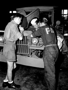SC 184880 - German war prisoners at Camp Wallace, Texas, assigned to work in the Ordnance Command Shop #5 take a great interest in the American automobile and truck.