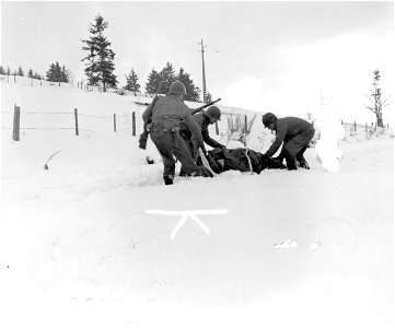 SC 199021 - 30th Division infantrymen, members of H Company, 2nd Battalion, 119th Regiment, bring in wounded comrade on a sled. photo