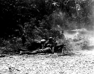 SC 364512 - 50 cal. machine gun with a 75mm gun in background firing at the Japs on Hill 1445. Puerto Princese, Palawan, P.I. photo