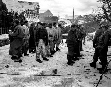 SC 199105 - German prisoners taken in the Ardennes sector by 3rd Armored Division are checked before being moved to cages. photo