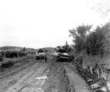 SC 348869 - Tank of the 5th Cav. Regt., 1st Cav. Div. pulls another tank from a ditch near Sindong, Korea, during action against the North Korean forces in that area. 19 September, 1950. photo