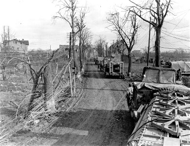 SC 334970 - Trucks and trailers loaded with pontoon bridge equipment, prepare to leave Lindern, Germany, to go to Linnich where Ninth U.S. Army troops are crossing the Roer River. photo