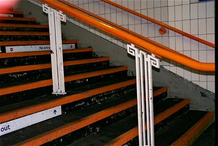 Handrail stanchions at West Croydon, thought to date from the construction of the new station building, in about 1930.  The orange colour is that of the London Overground.