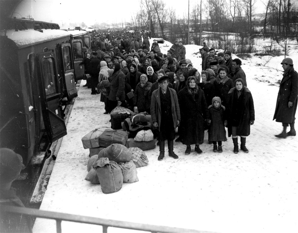 SC 199113 - Russian war refugees, having been liberated from German forced labor by the U.S. Army, prepare to board train which will take them to a misplaced persons camp in the interior of France. Chalons, France. 10 January, 1945.