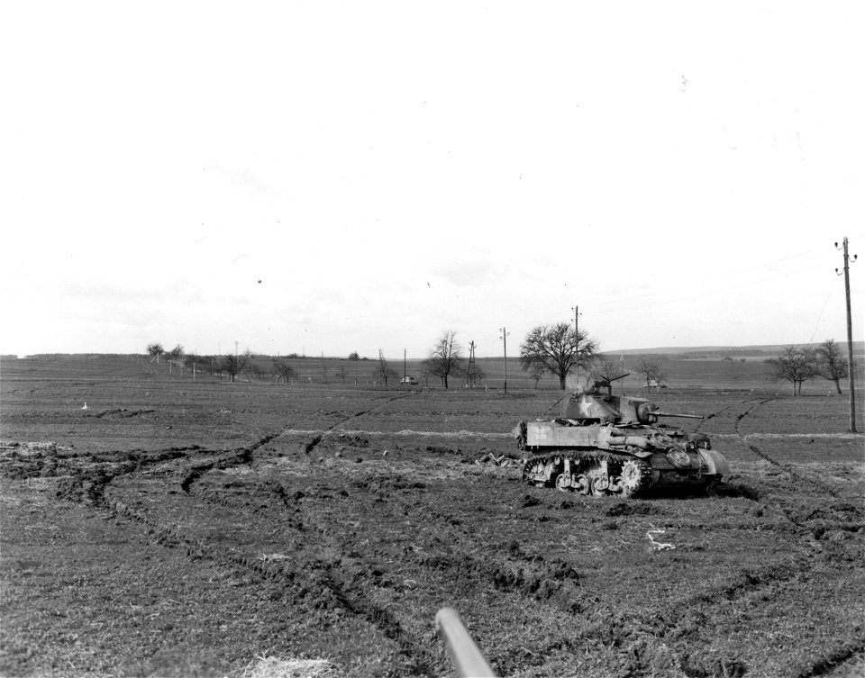 SC 364384 - Tanks stand in the field on the edge of a German town not yet taken, but in which fanatic Hitler Youth held against certain death.