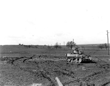 SC 364384 - Tanks stand in the field on the edge of a German town not yet taken, but in which fanatic Hitler Youth held against certain death. photo