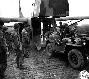 SC 195698 - Members of an Airborne unit load a jeep into the "mouth" of a glider in preparation for the airborne invasion of Holland which was successfully launched from airports "somewhere" in England. 17 September, 1944. photo