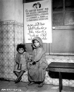 SC 170068 - Two Arab children that have received their daily ration of 3/4 pint of milk at a girls' school in N. Africa. photo