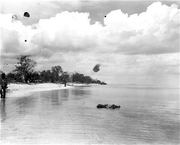 Signaling position for landing of LVTs on northern Saipan beach is Marine Pfc. Baldwin Ford, 1424 Richmond Rd., So. Euchlid, Ohio.