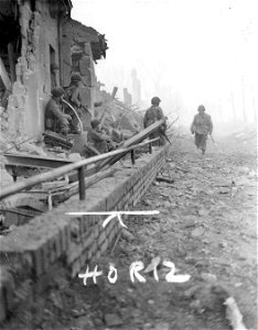 SC 334967 - Infantrymen of the 29th Division, 9th U.S. Army, take cover in ruined building in Julich, Germany, where they are fighting enemy troops.