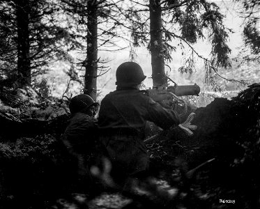 SC 364318 - Machine gunners of the 2nd Platoon, Company "B", 134th Infantry Regiment, 35th Infantry Division, in positions just taken from Nazis being pushed out of Rundstedt's Ardennes salient. photo