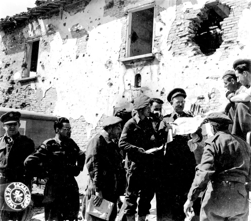 SC 364851 - The rabbi of the Jewish Inf. Brigade visits the aid station and distributes newspapers. 30 March, 1945.
