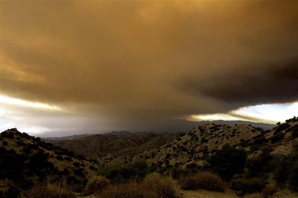 Smoke from the Apple Fire over desert hills