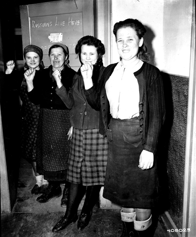 SC 405023 - Four Russian women forced to accompany German troops for washing and cooking duties from the Eastern Front, indicate their pleasure at being freed again with a salute.