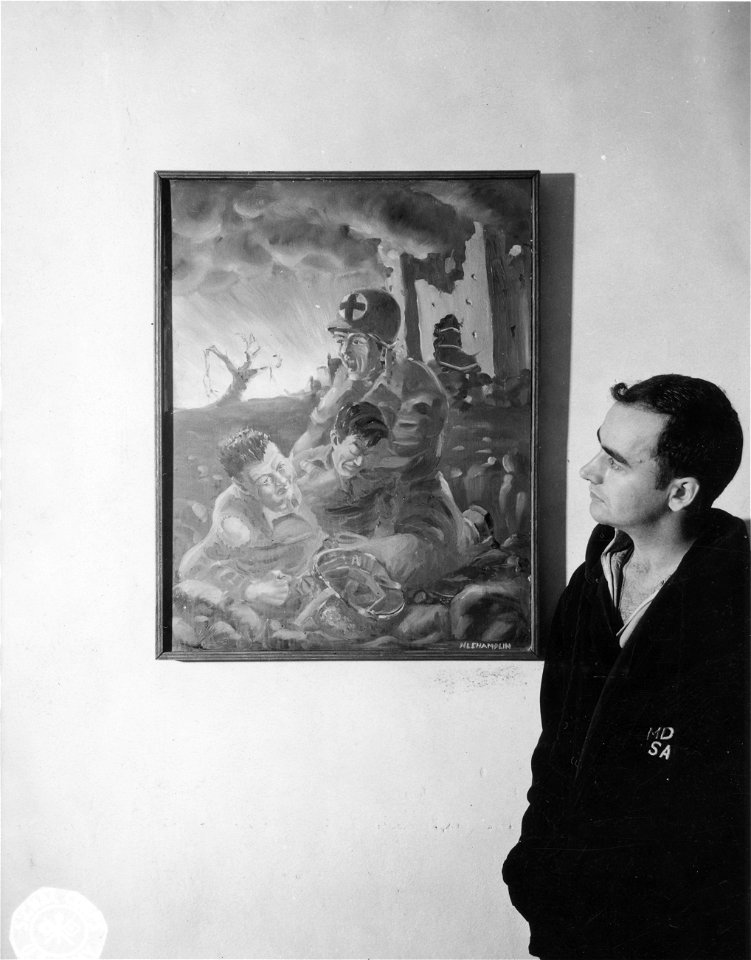 SC 374648 - 2nd Lt. N.L. Champlin, Newport, R.I., beside his painting of the medics at work on the battlefield.