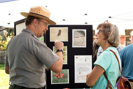 Visitor and Ranger Speak at Monarch Butterfly Exhibit photo
