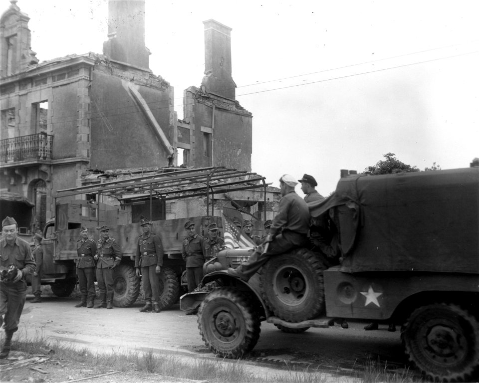 SC 364335 -  American sailors from Cherbourg went along for the ride when the 66th Inf. Division entered Lorient, France, following the surrender of the 28,000-man German garrison.
