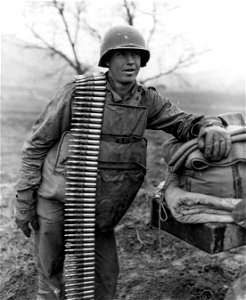 SC 364044 - Pfc. V.L. Creswell, Newport, Ark., 25th Inf. Div., an ammo bearer on a quad fifty machine gun, rests while he waits to reload the the blazing gun somewhere along the central front in Korea. photo