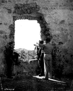 SC 180064 - Col. Edgar Erskine Hume, Frankfort, Ky., points out the city of Agropoli to two Italian policemen.