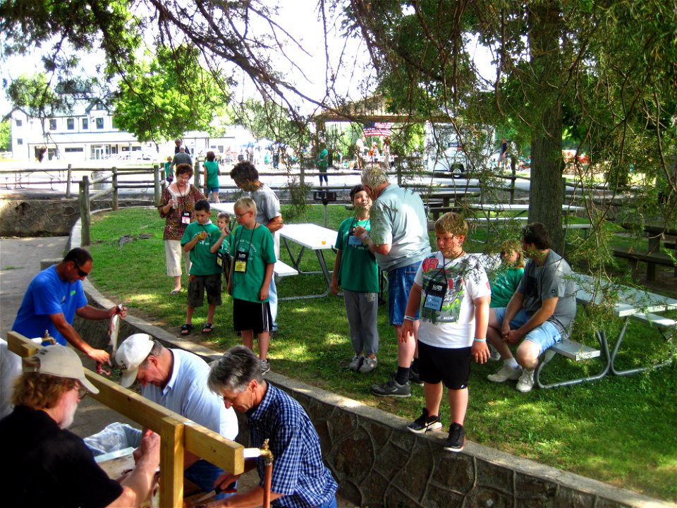 Hungry participants watch the fish cleaners.