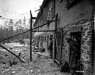 SC 270569 - American soldiers of Co. G, 38th Regiment, 2nd Division, U.S. First Army, take refuge in doorways during mortar barrage laid down by Germans after Yanks seized one of their forest strongholds... photo