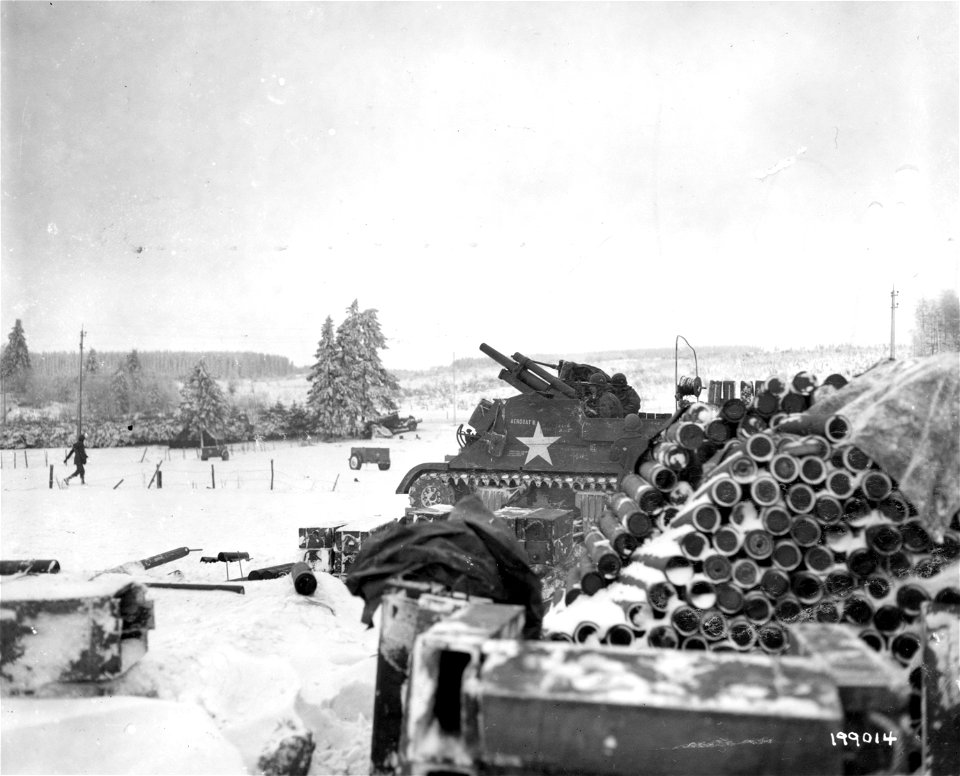 SC 199015 - The crew of an M-7 tank, U.S. Third Army, prepare their 105mm howitzer for action, in Morhet, Belgium. 9 January, 1945.