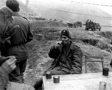 SC 364042 - Lt. Col. Dumoncel, C of S French Bn. enjoys chow during a break in action against the Chinese Communist enemy forces, near Oum-Ni, Korea. photo