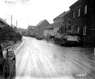 SC 335254 - Tanks of the 9th Armored Division, U.S. First Army, advance to the front through the town of Kleinbullesheim, Germany. 6 March, 1945. photo