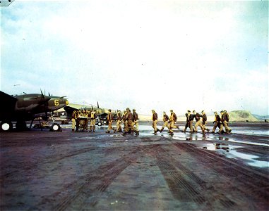 C-802 - Adak Island, Aleutians. Pilots of a fighter squadron shown walking towards their P-38 prior to take-off on a mission.