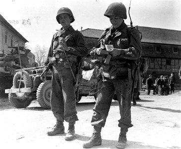 SC 396854 - Eating K rations somewhere in Germany are, left to right: Pfc. Marvin Beard, Reeves, Tenn., and Pfc. Philip Isaacs, New Haven, Conn.