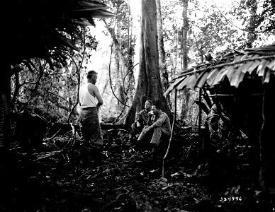 SC 334996 - Gen. J. Lawton Collins, CG of the 25th Division, (back to camera) performs his morning ablutions, while Colonel D. H. Buchanan, CO of the 3rd Battalion, 161st Infantry, and Col. R. L. Stevenson, G-2, 25th Division... photo