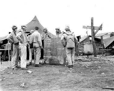 Upon returning, the intelligence officer Lt. Harrison, checks off the names of the pilots. Guadalcanal. June, 1943.