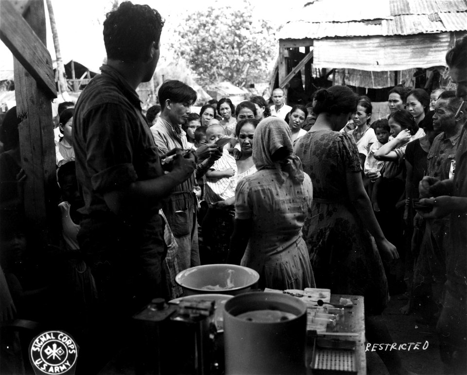 SC 405073 - Saipan. Army medics give Chomoros vaccinations in one of the many small villages. July, 1944.