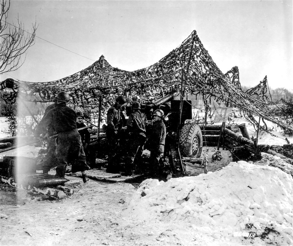 SC 364313 - A 155mm howitzer of the 751st Field Artillery Battalion being loaded for a fire mission. Near Rotgen, Germany.