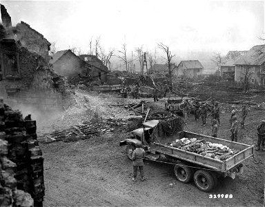 SC 329988 - Infantrymen are working with engineers in road repair near Bullingen, Belgium, to keep supplies moving to the front. photo