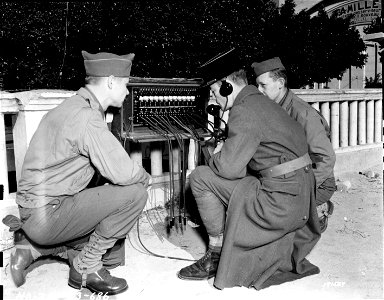 SC 171567 - American soldiers teach French Army officers and man the use of American military equipment. A BD-72 Field Switchboard in operation near Algiers, North Africa. 9 February, 1943. photo