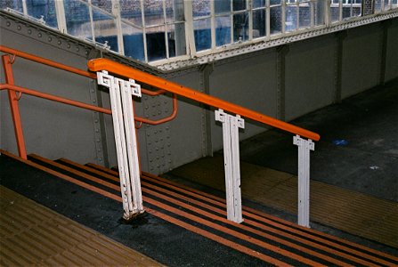 Handrail stancions at West Croydon, thought to date from the construction of the new station building, in about 1930.  The orange colour is that of the London Overground.